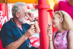 happy senior friend couples enjoy in amusement water park with icecream