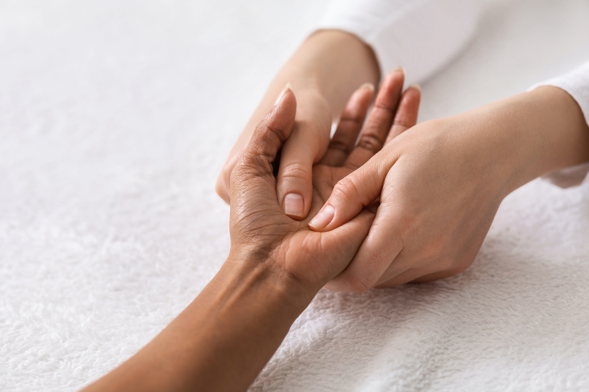 Acupuncture hand massage for black woman at spa