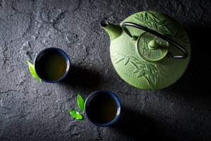 Aromatic green tea on black rock. Chinese cuisine.