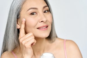 Closeup portrait of happy middle aged mature asian woman. Skin care ads.