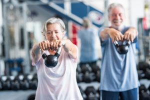 couple of two active and healthy seniors or pensioners or mature people doing exercise