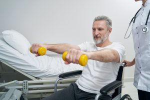 Disabled person doing strength training exercise with physiotherapist