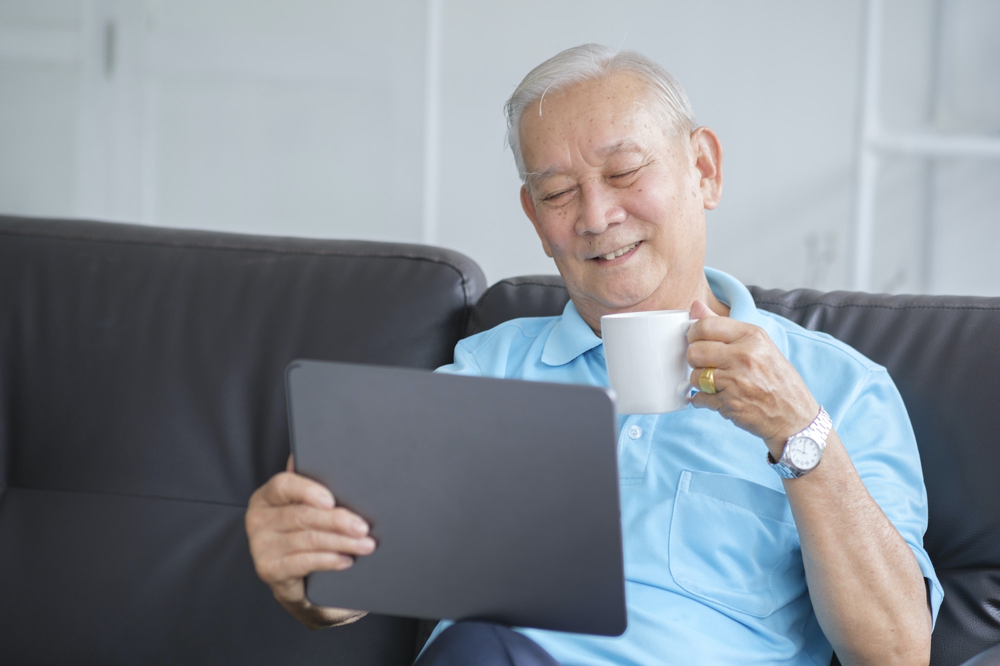 Happy senior man using online techology.