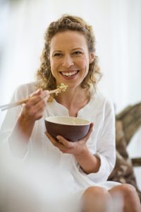 middle-aged woman eating healthy food