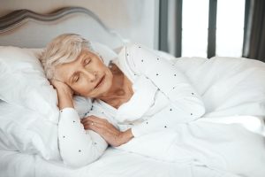 Quality sleep, quality life. Shot of a senior woman sleeping in bed in a nursing home.