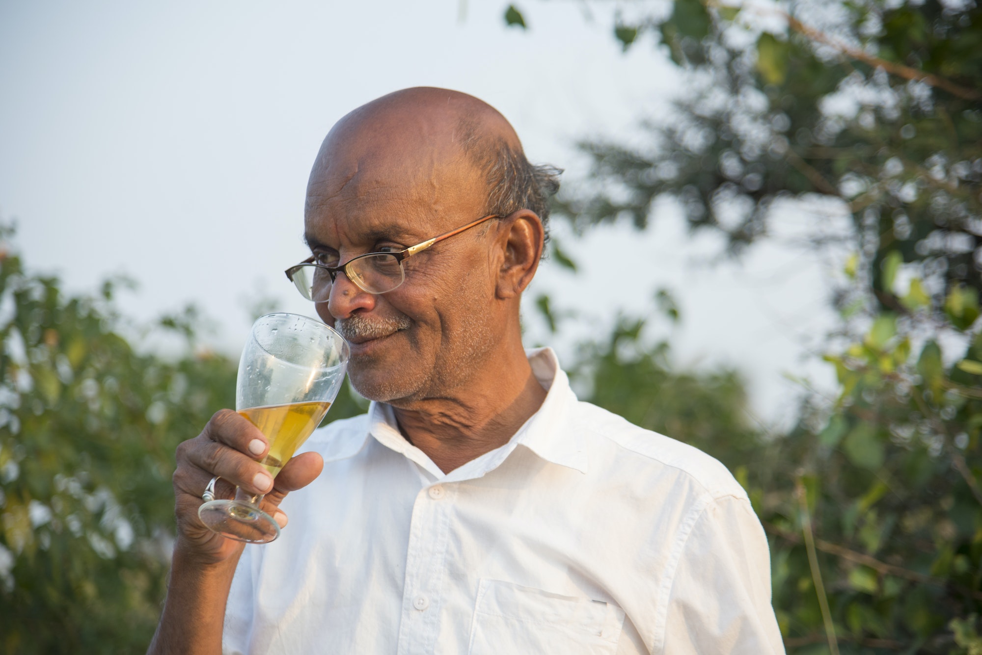 Senior Indian man drinking alcohol and enjoy relax.