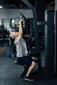 senior sportsman lifting weights in sport center