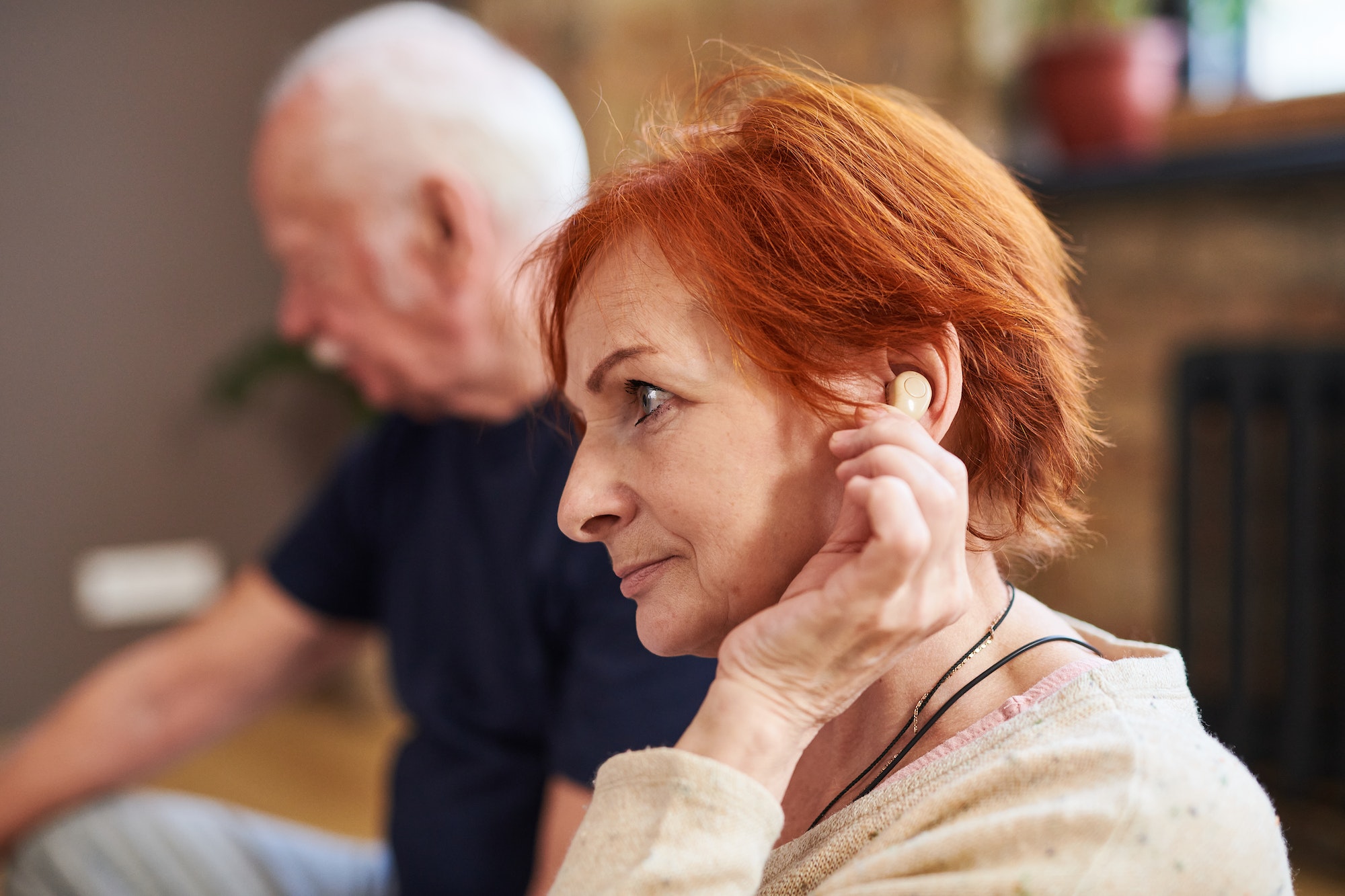 Senior woman using hearing aid